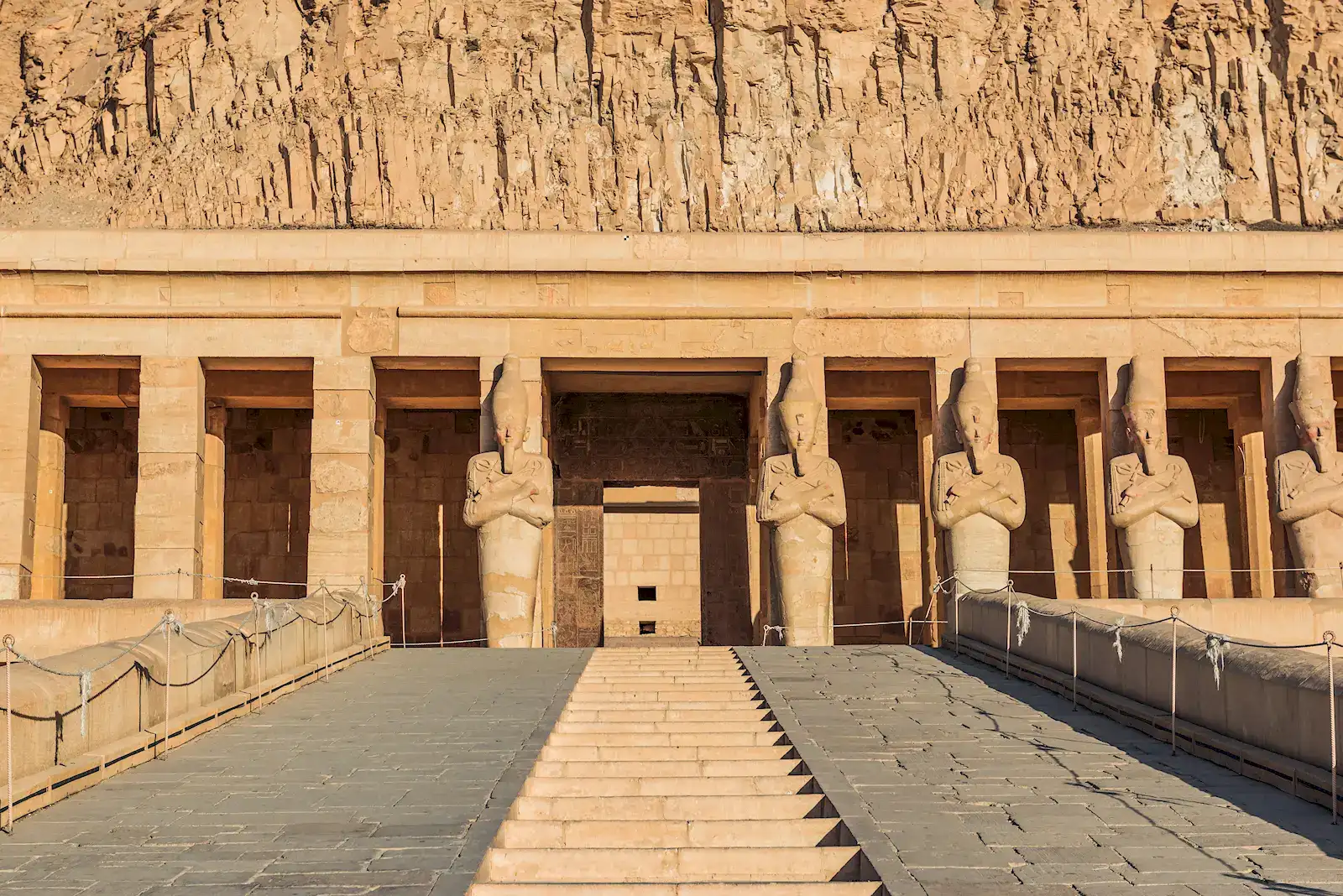 The terraced temple of Hatshepsut beneath desert cliffs near Luxor, Egypt