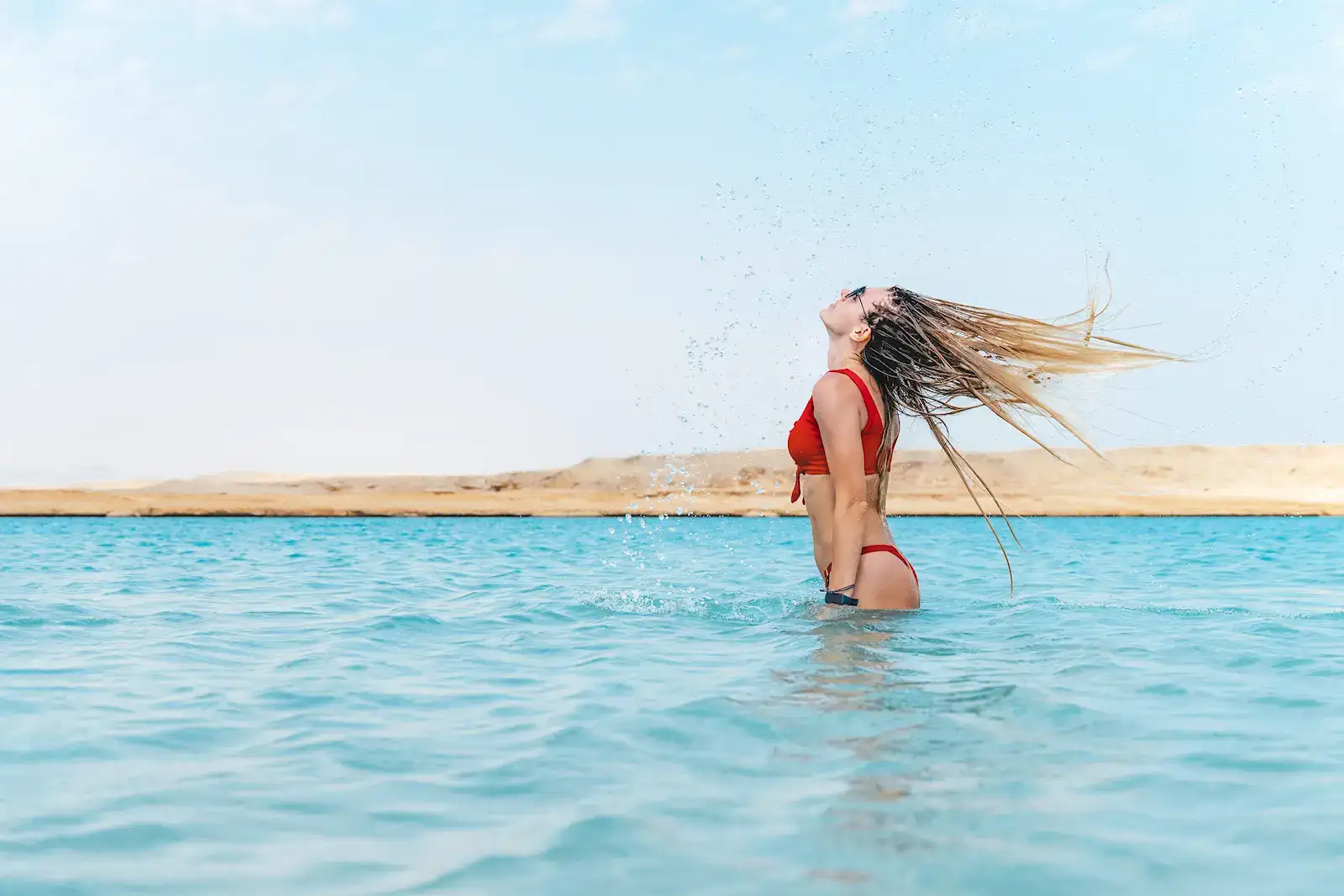 A woman traveller enjoying the sea at a Red Sea resort near Dahab, Egypt